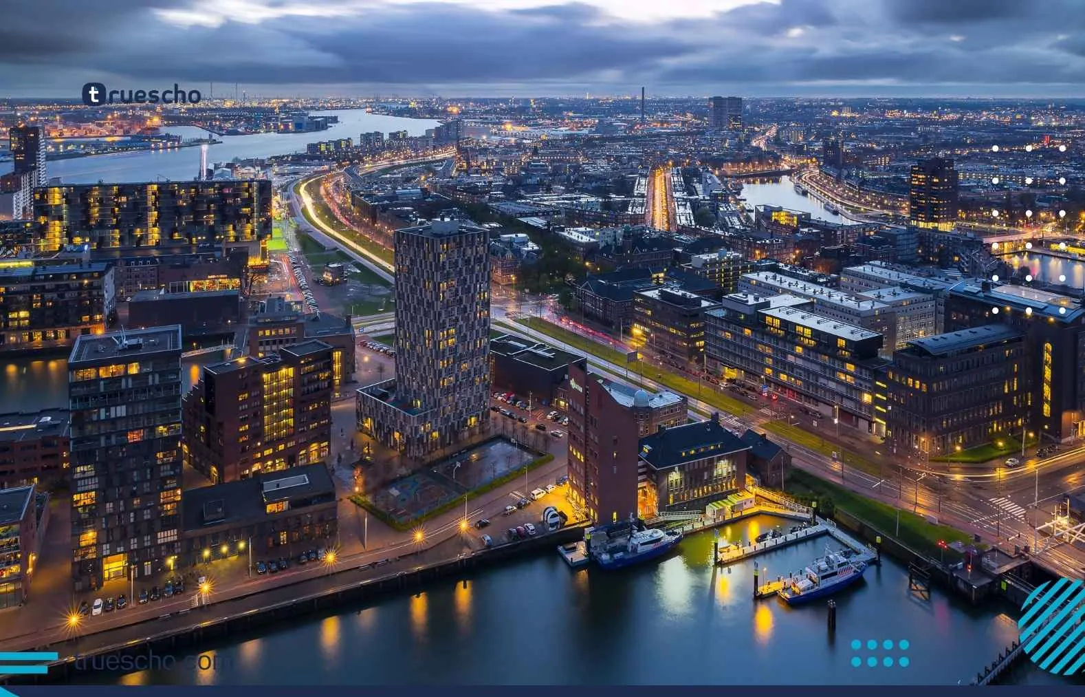 Aerial night view of a Dutch city with illuminated buildings and canals &mdash; Netherlands.