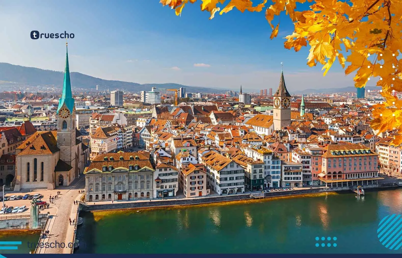 Zurich city skyline with church towers and autumn leaves over the Limmat River in Switzerland